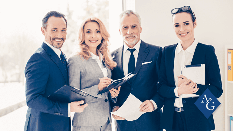 4 people wearing suits and posing for a picture