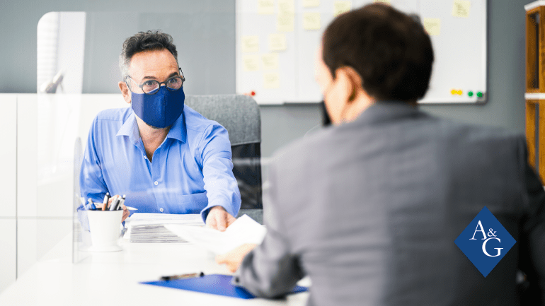 Man handing papers to other man