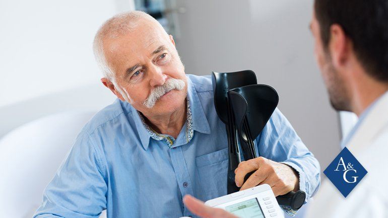 Older man holding crutches