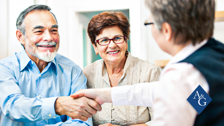 Elderly couple shaking hands
