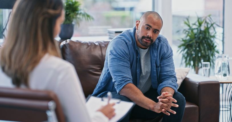 man speaking with a therapist